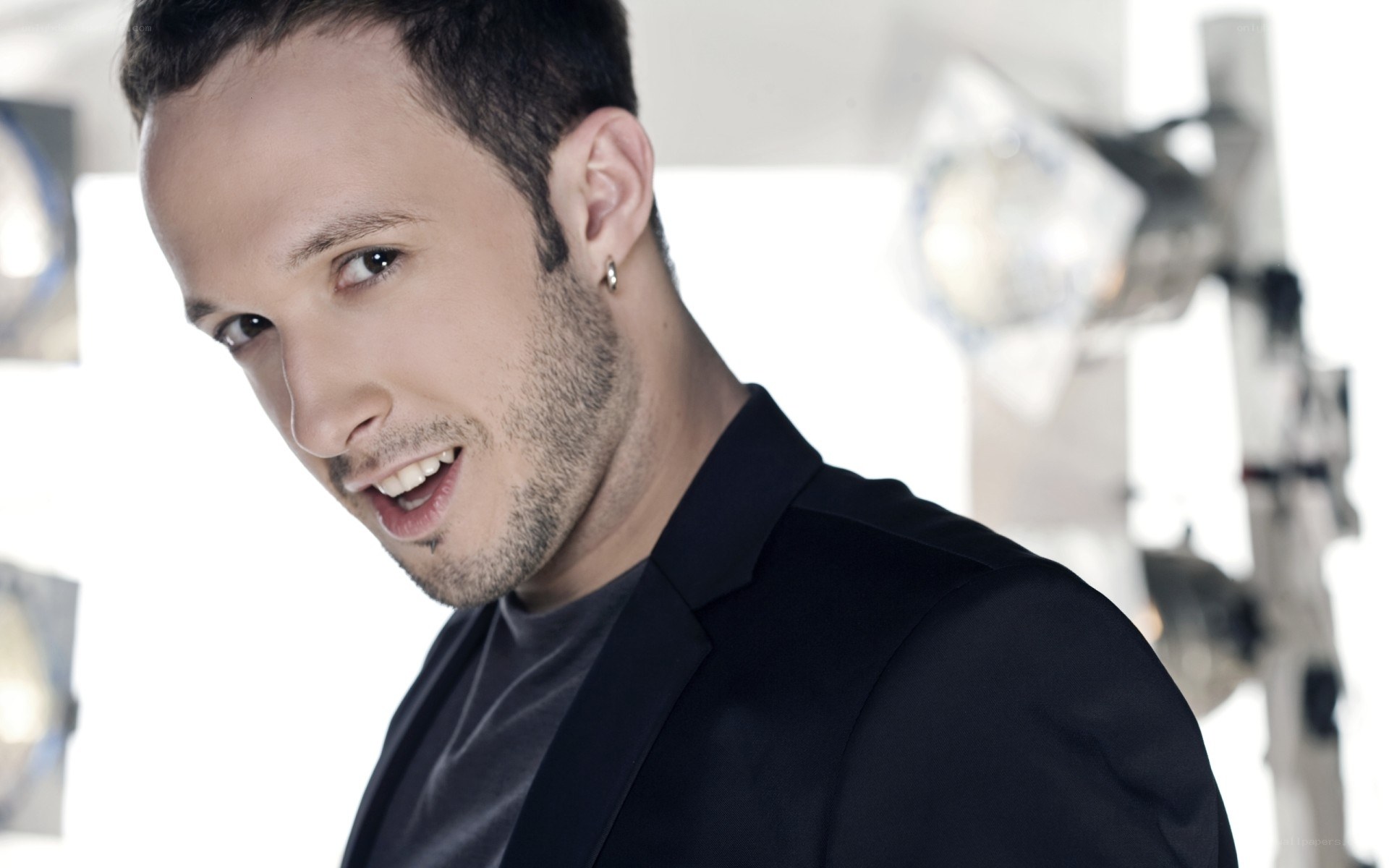 man in black suit smiling