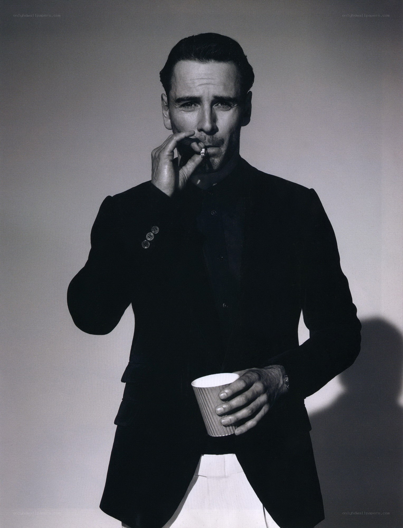 man in black suit smoking