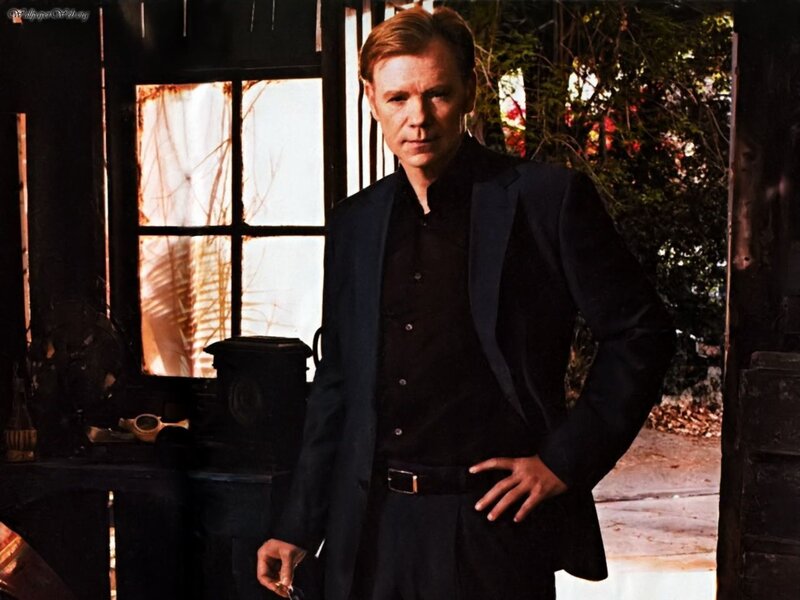 man in black suit standing