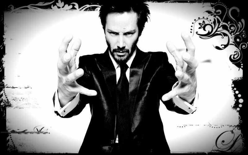 man in black suit with hands out