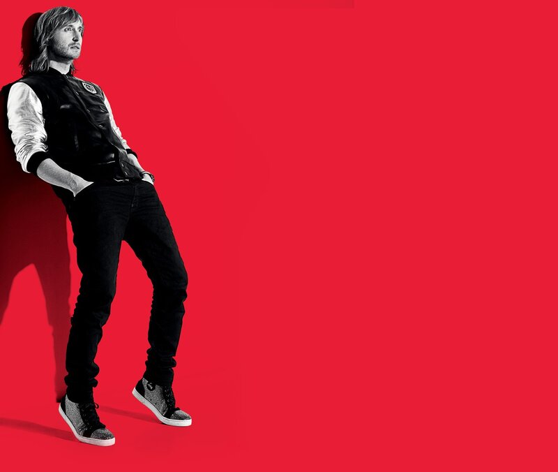 man in black vest against red