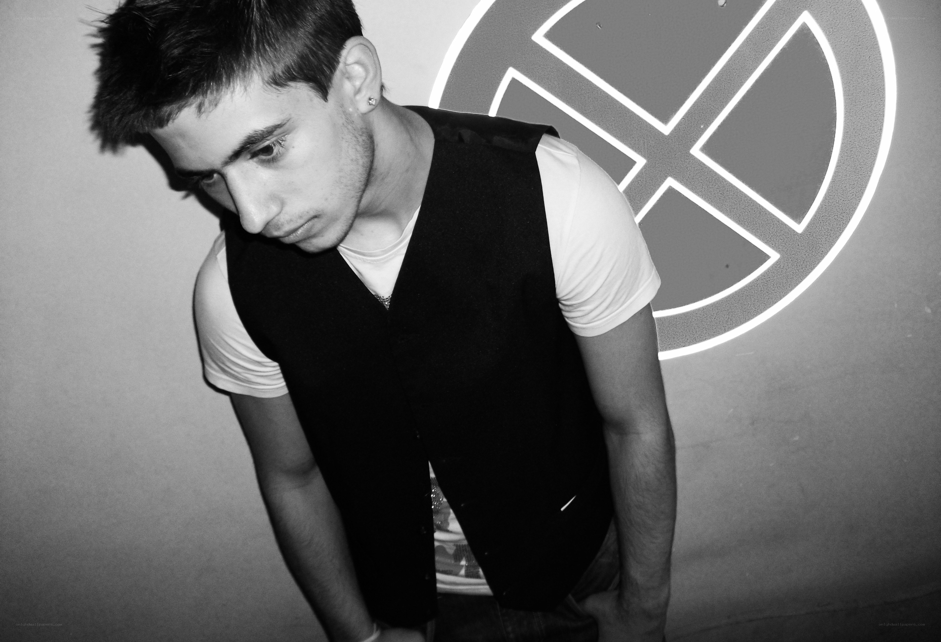 man in black vest looking down