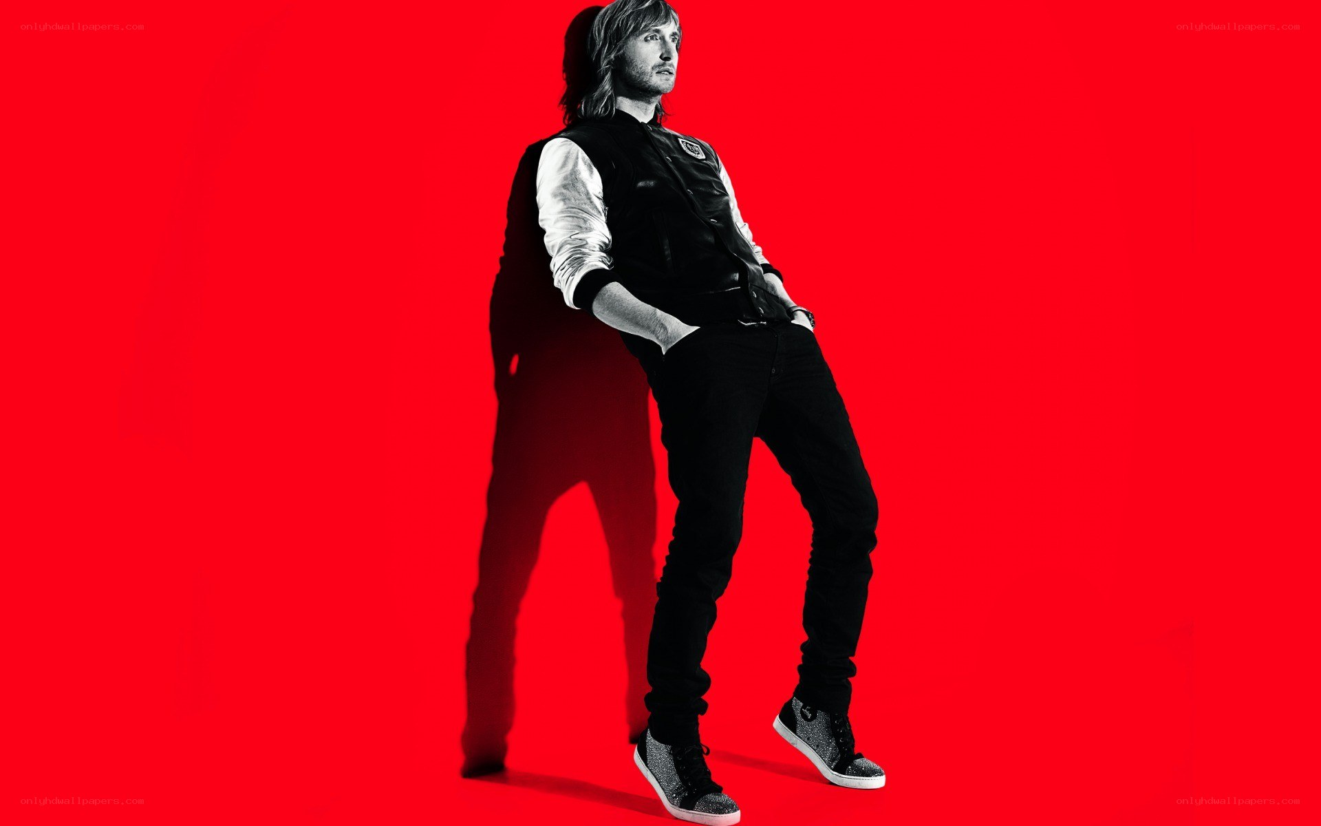 man in black vest on red background