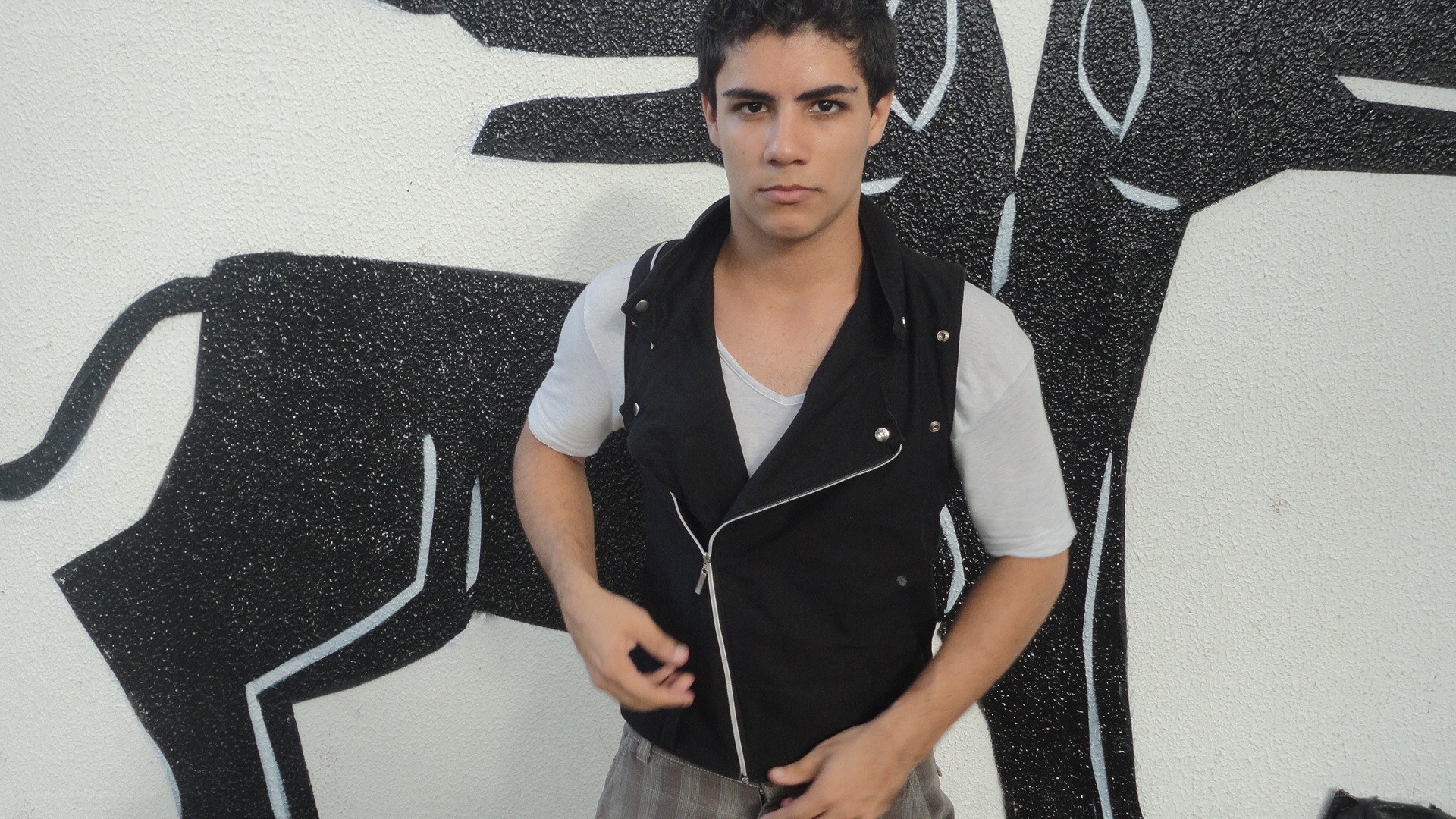 man in black vest standing