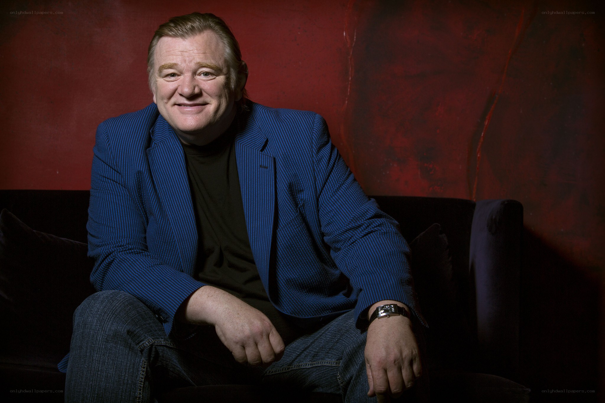 man in blue blazer sitting