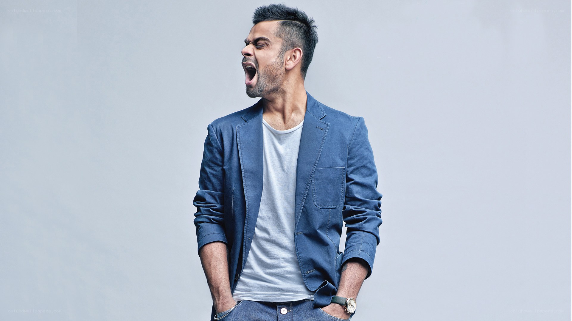 man in blue blazer yawning
