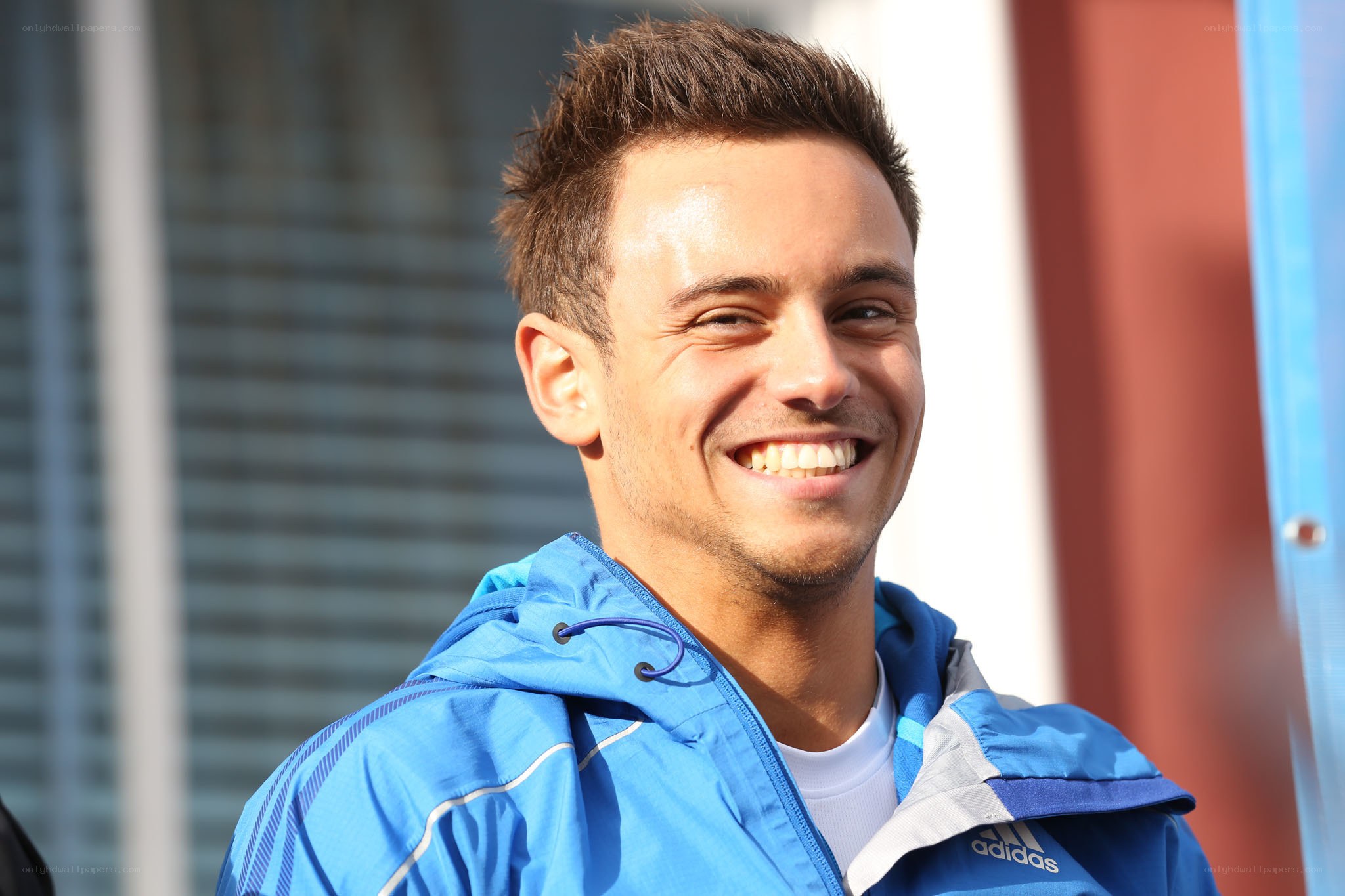man in blue jacket smiling