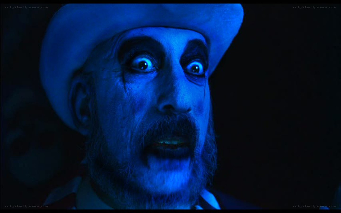 man in blue light with clown makeup