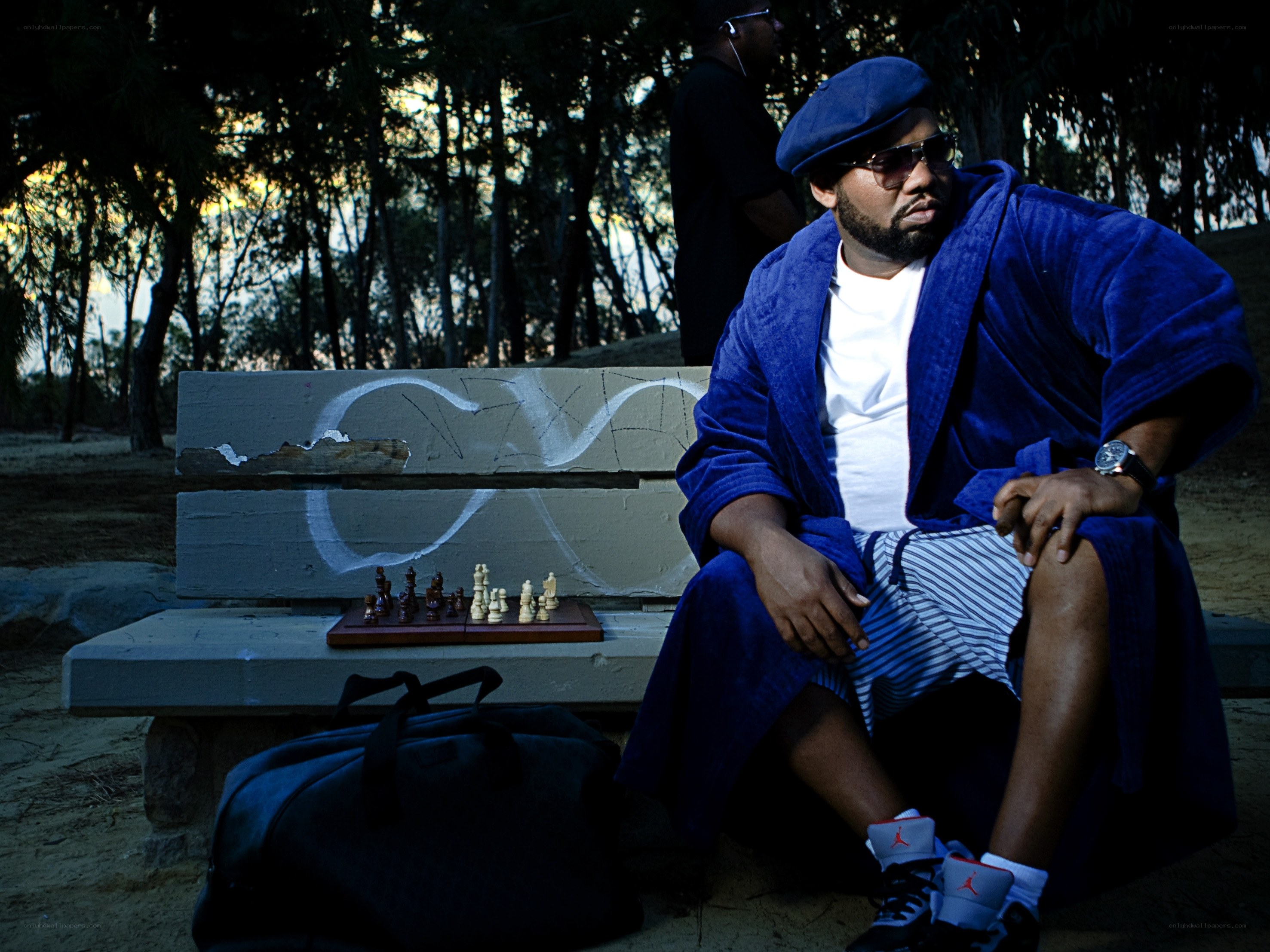 Man in blue robe on bench