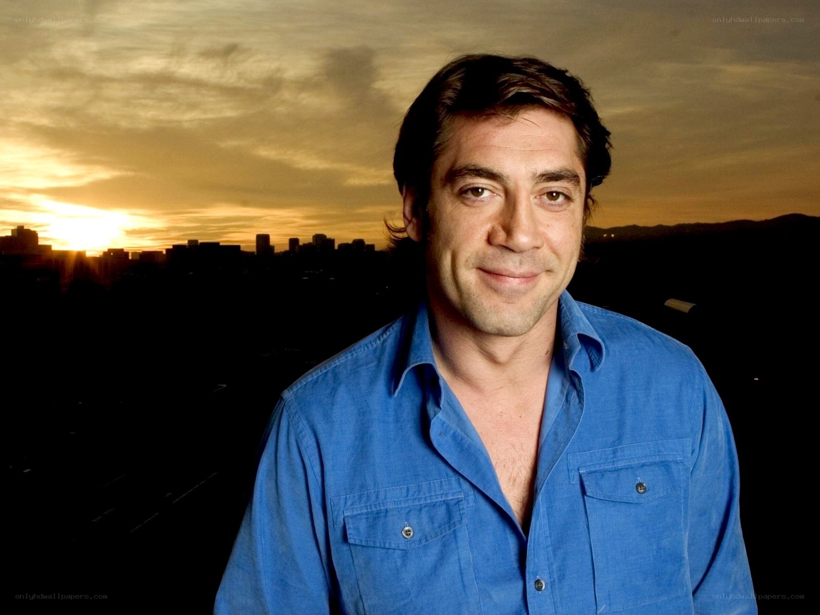 man in blue shirt at sunset