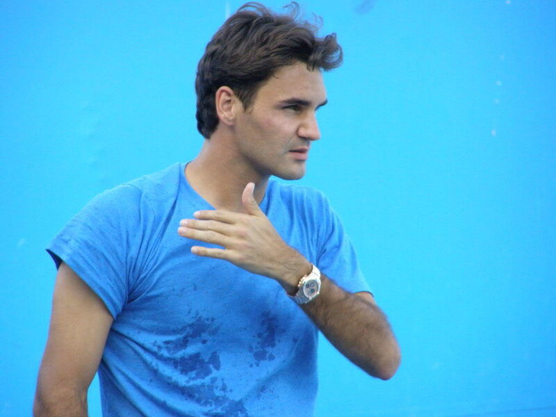 man in blue shirt gesturing