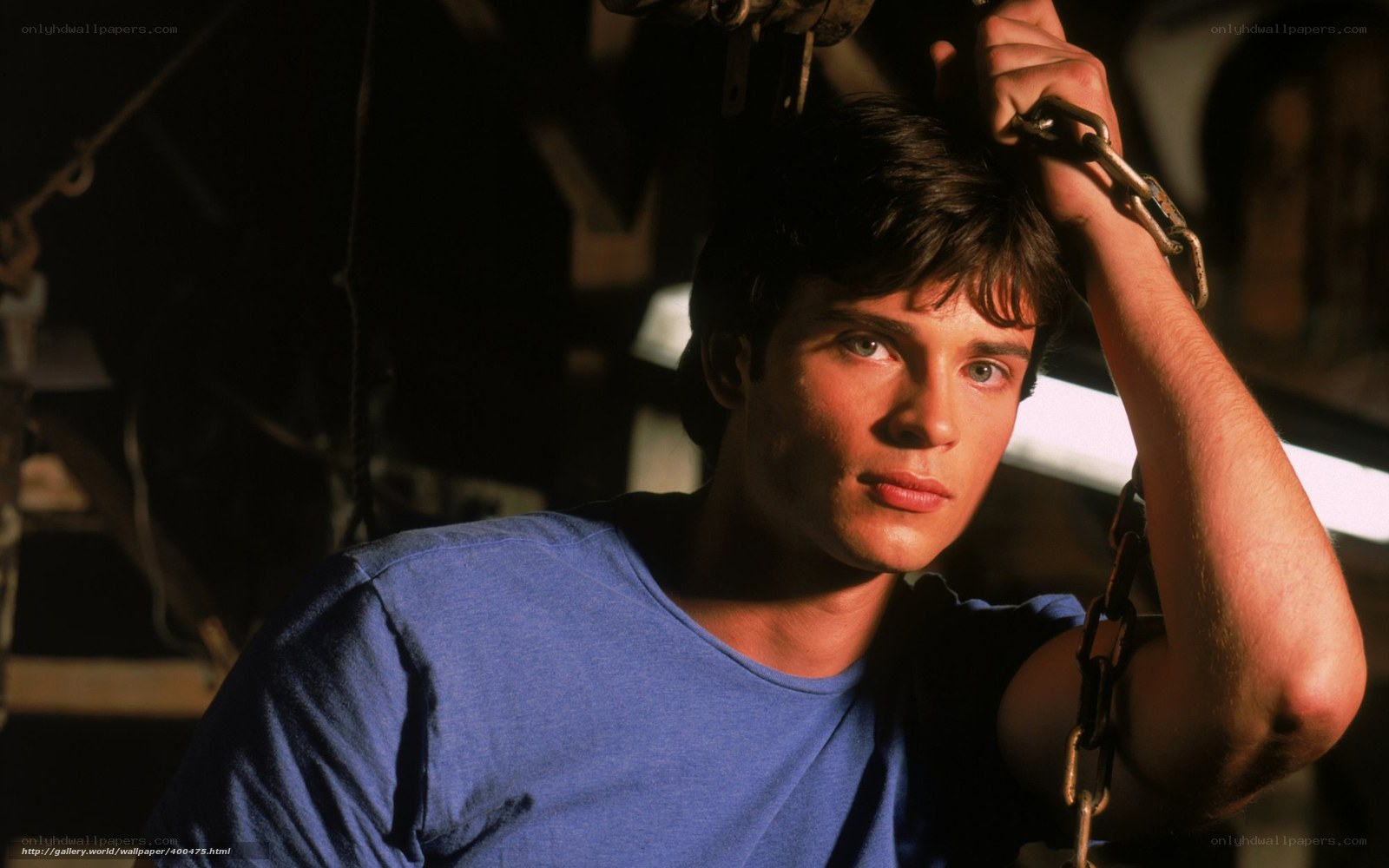 man in blue shirt holding chains