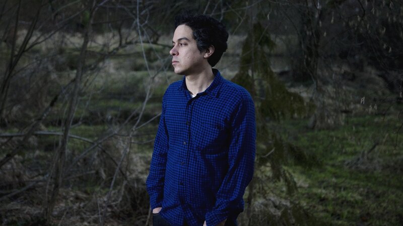 Man in blue shirt in forest