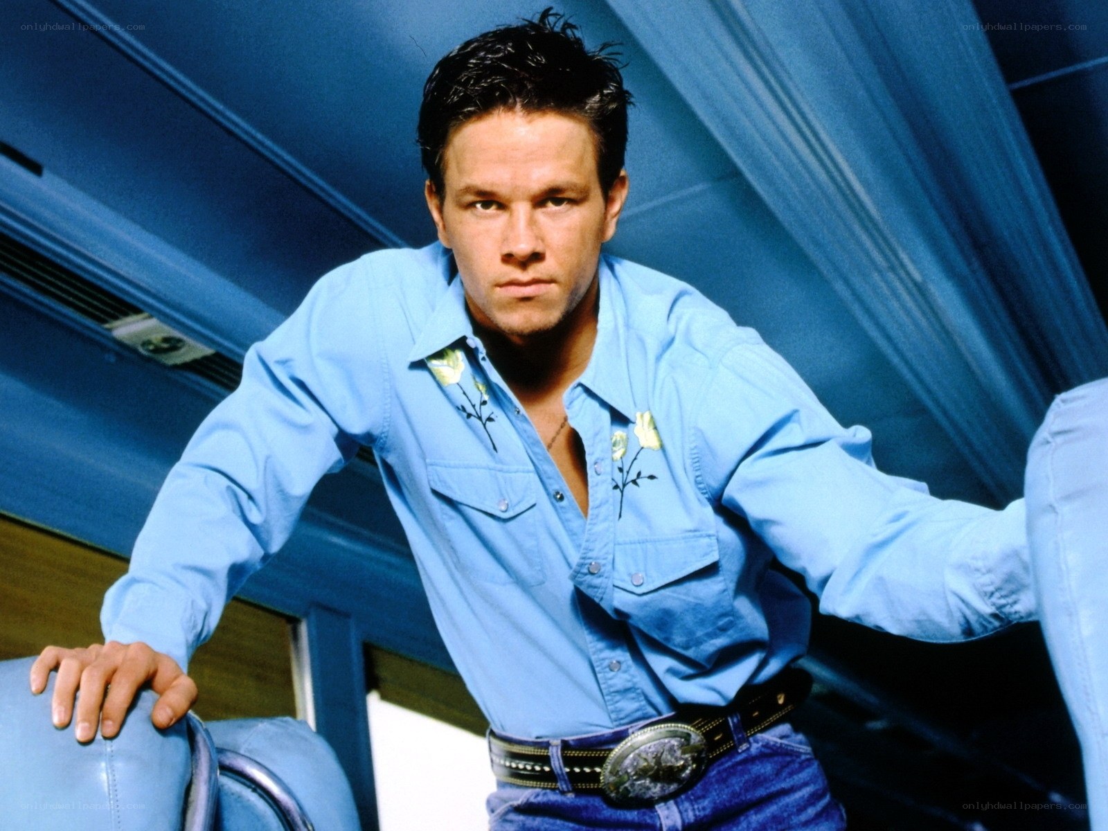 man in blue shirt leaning