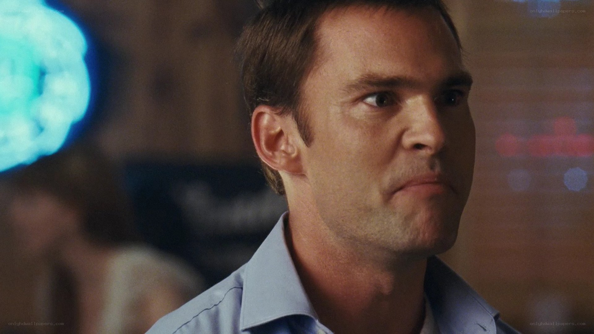 man in blue shirt looking away