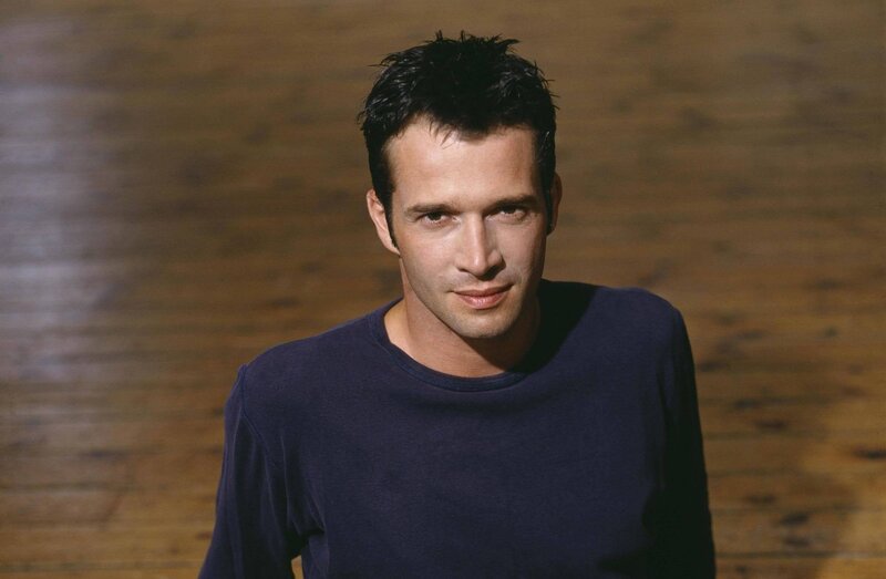 Man in Blue Shirt — Neutral, Photograph, Wooden Floor