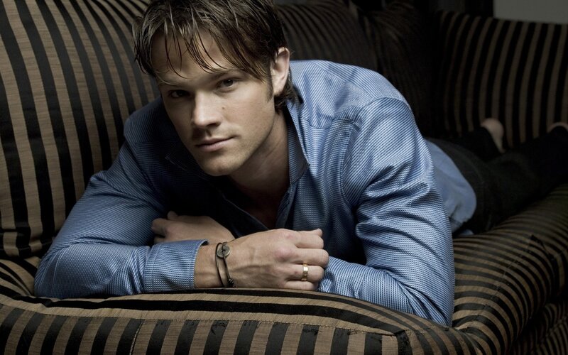 man in blue shirt on striped couch