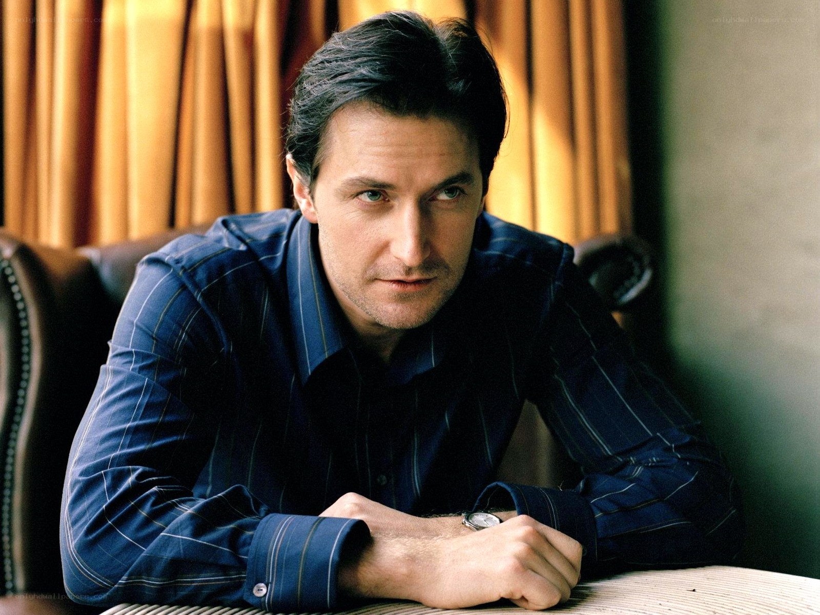man in blue shirt sitting