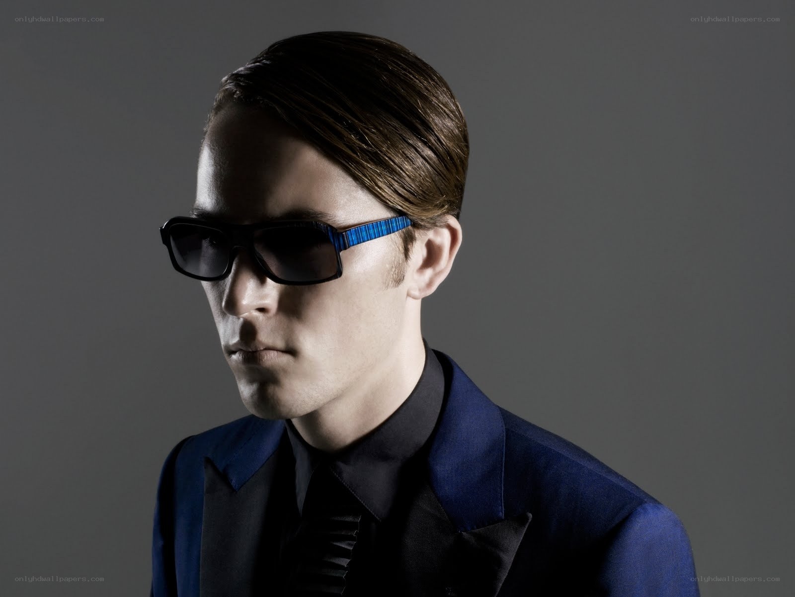 man in blue suit and sunglasses