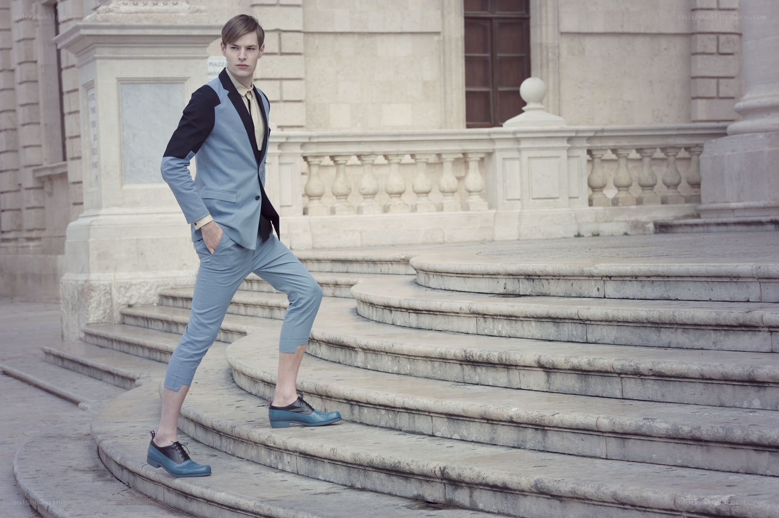 man in blue suit on steps