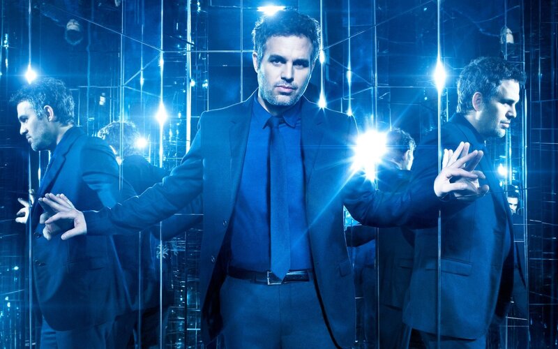 man in blue suit surrounded by mirrors