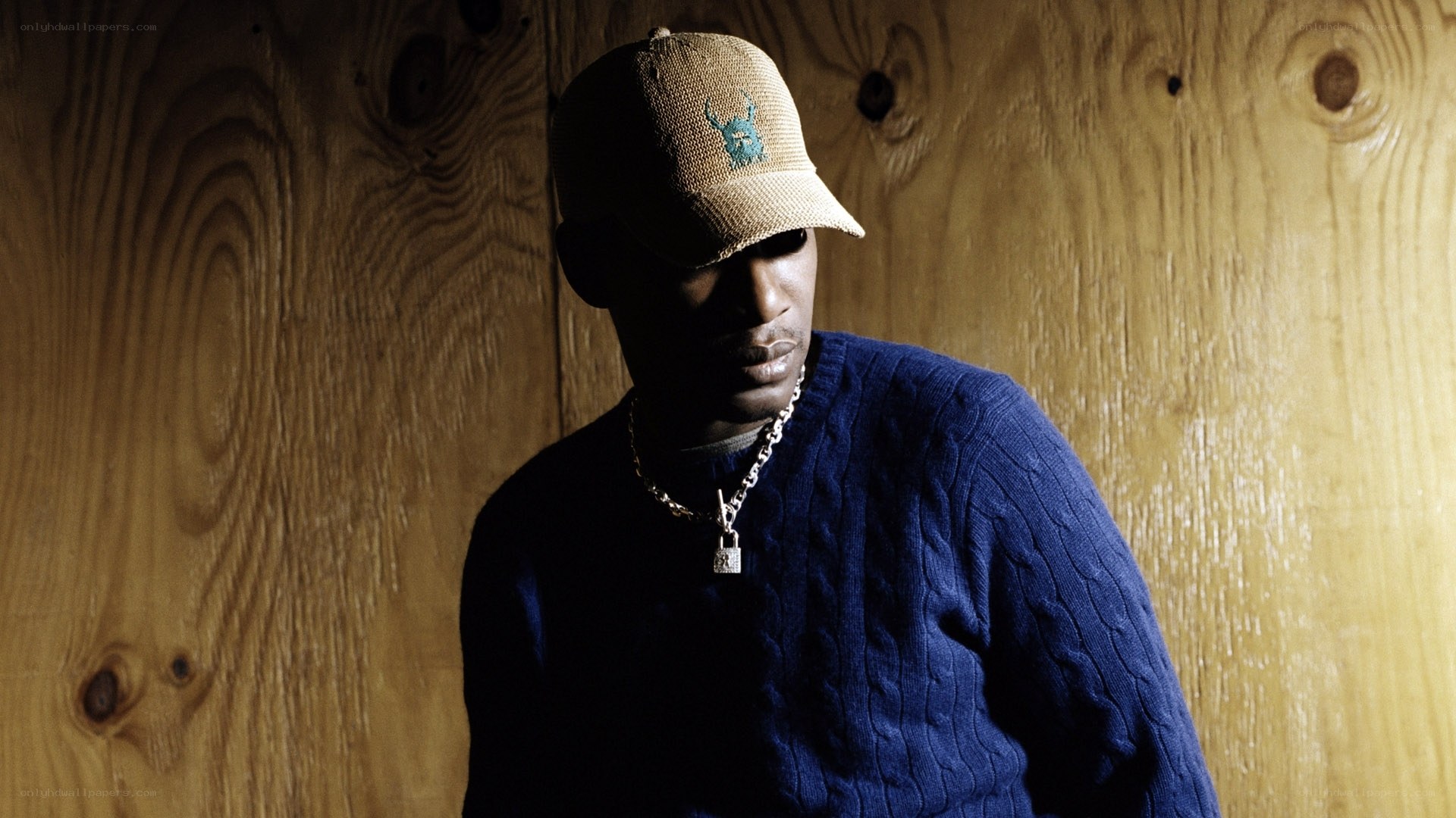 man in blue sweater and cap