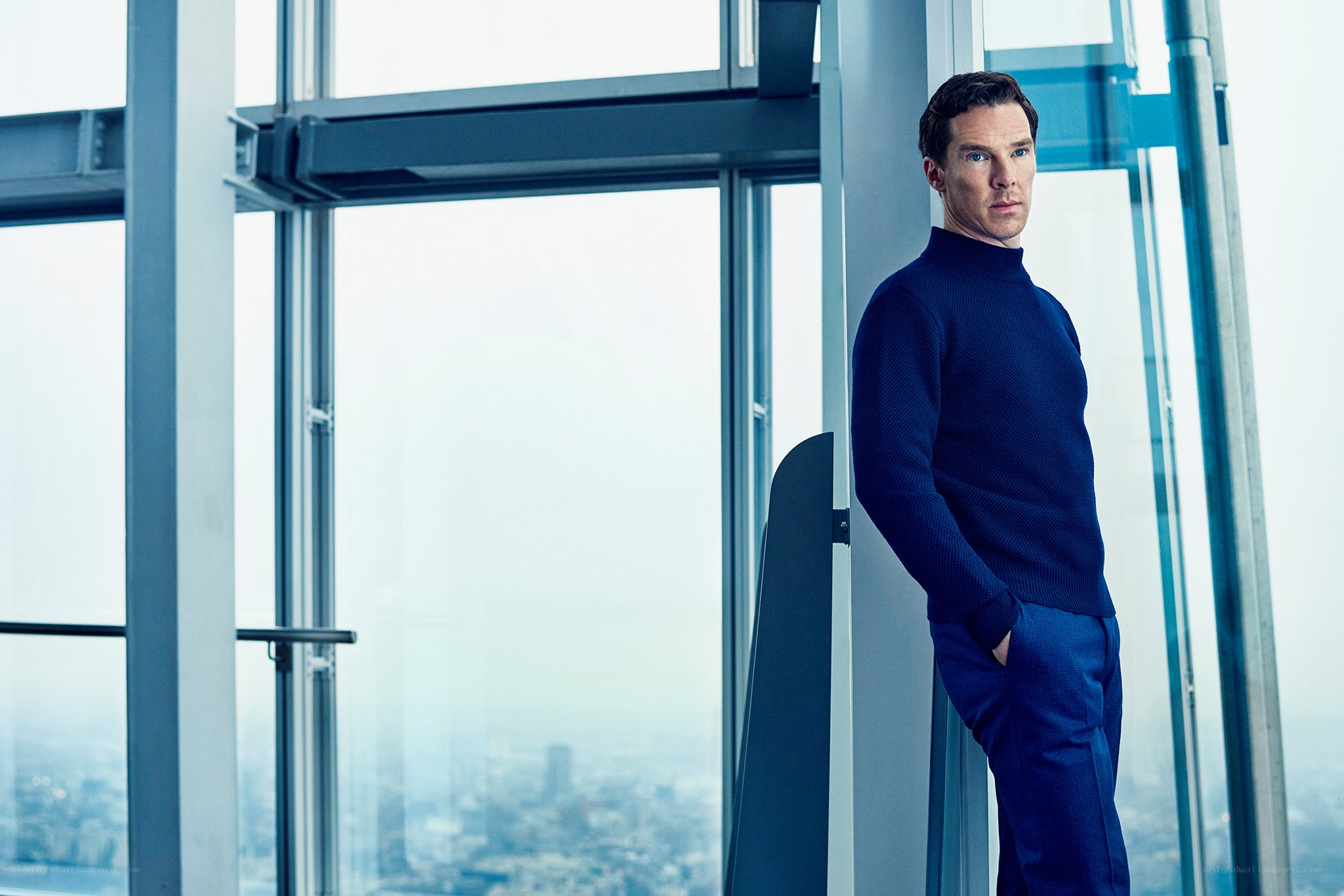 Man in blue sweater by window