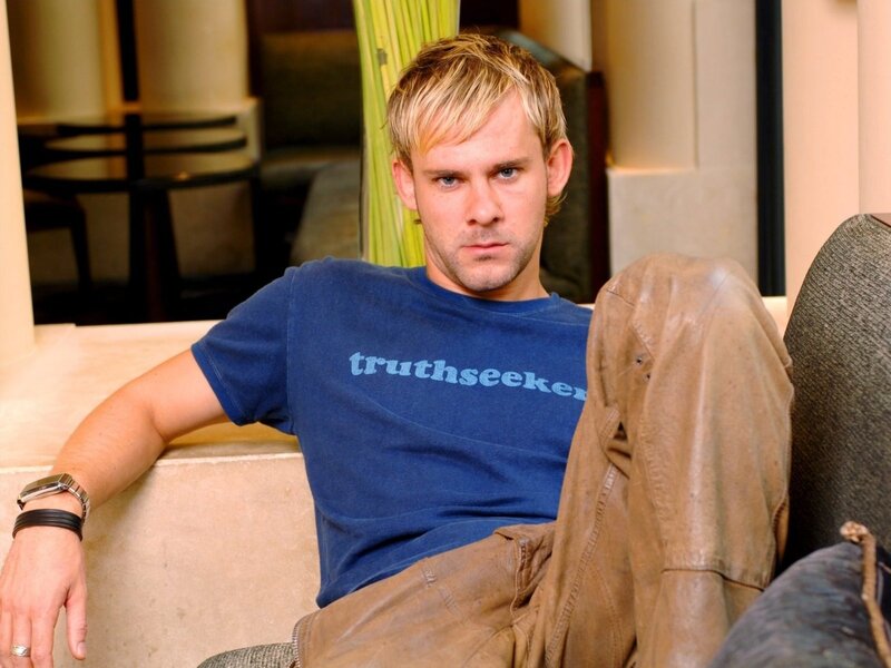 man in blue t-shirt sitting
