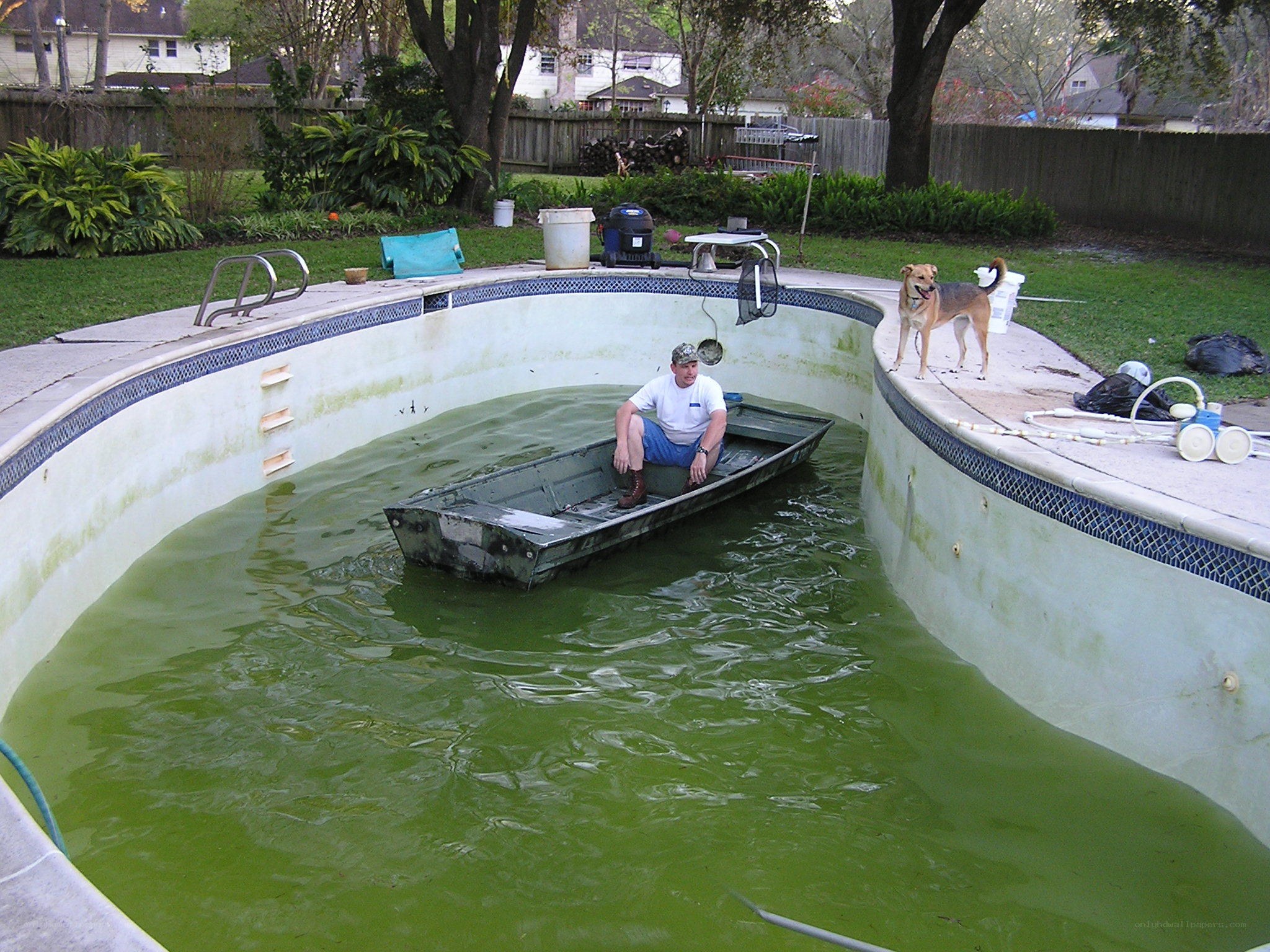 Man in boat in green pool
