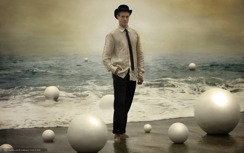 Man in bowler hat on beach