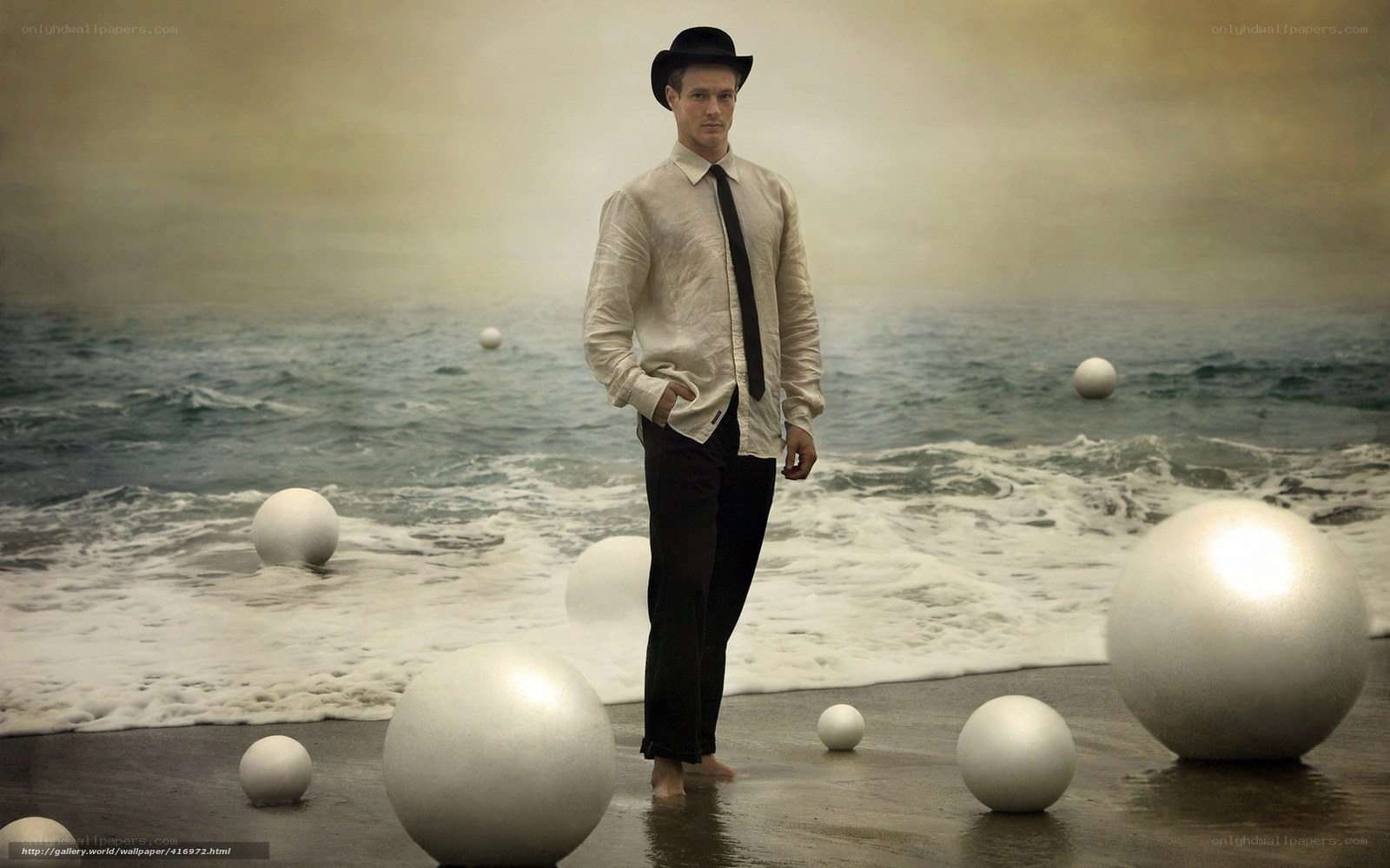 Man in bowler hat on beach