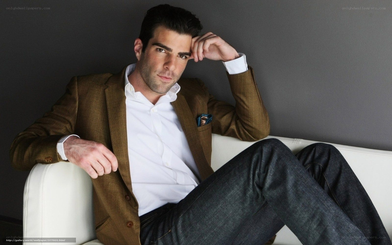 man in brown blazer sitting