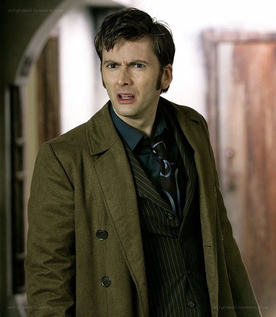 man in brown coat looking surprised