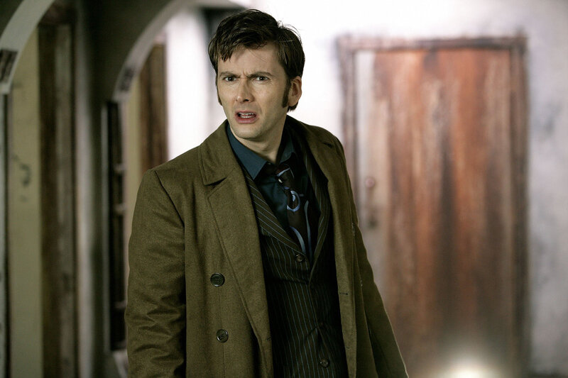 man in brown coat looking surprised