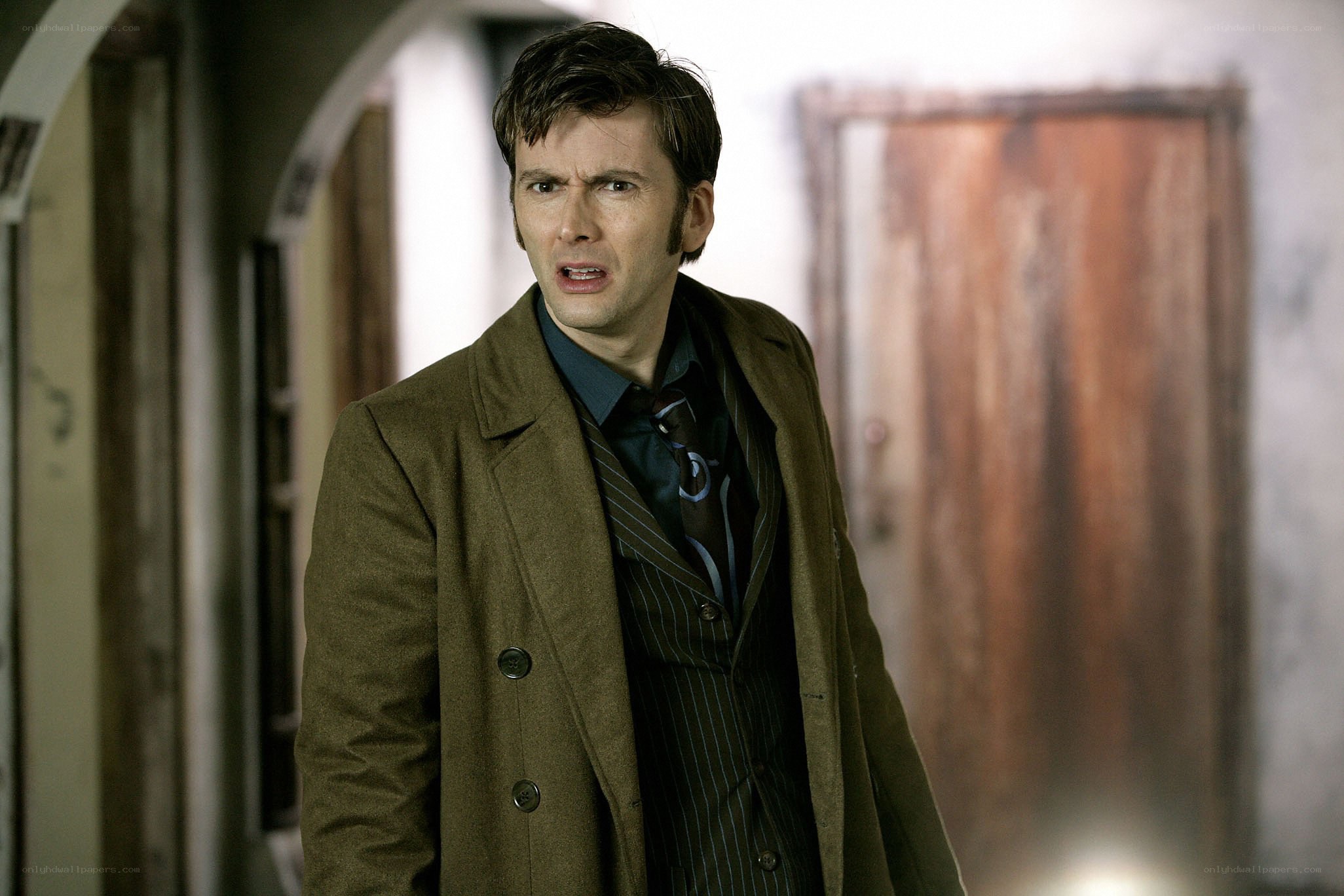 man in brown coat looking surprised