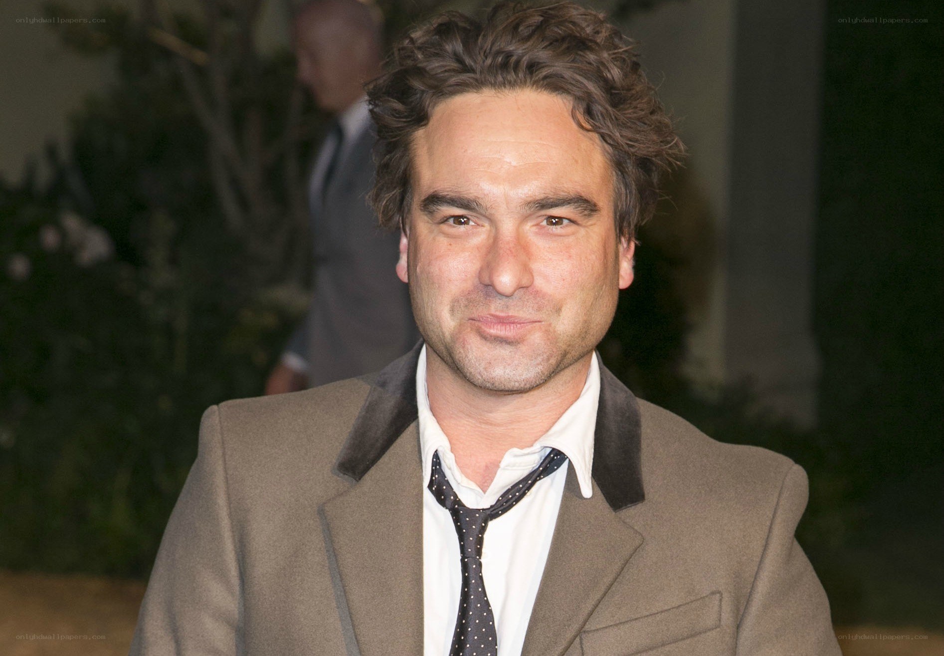 man in brown coat smiling