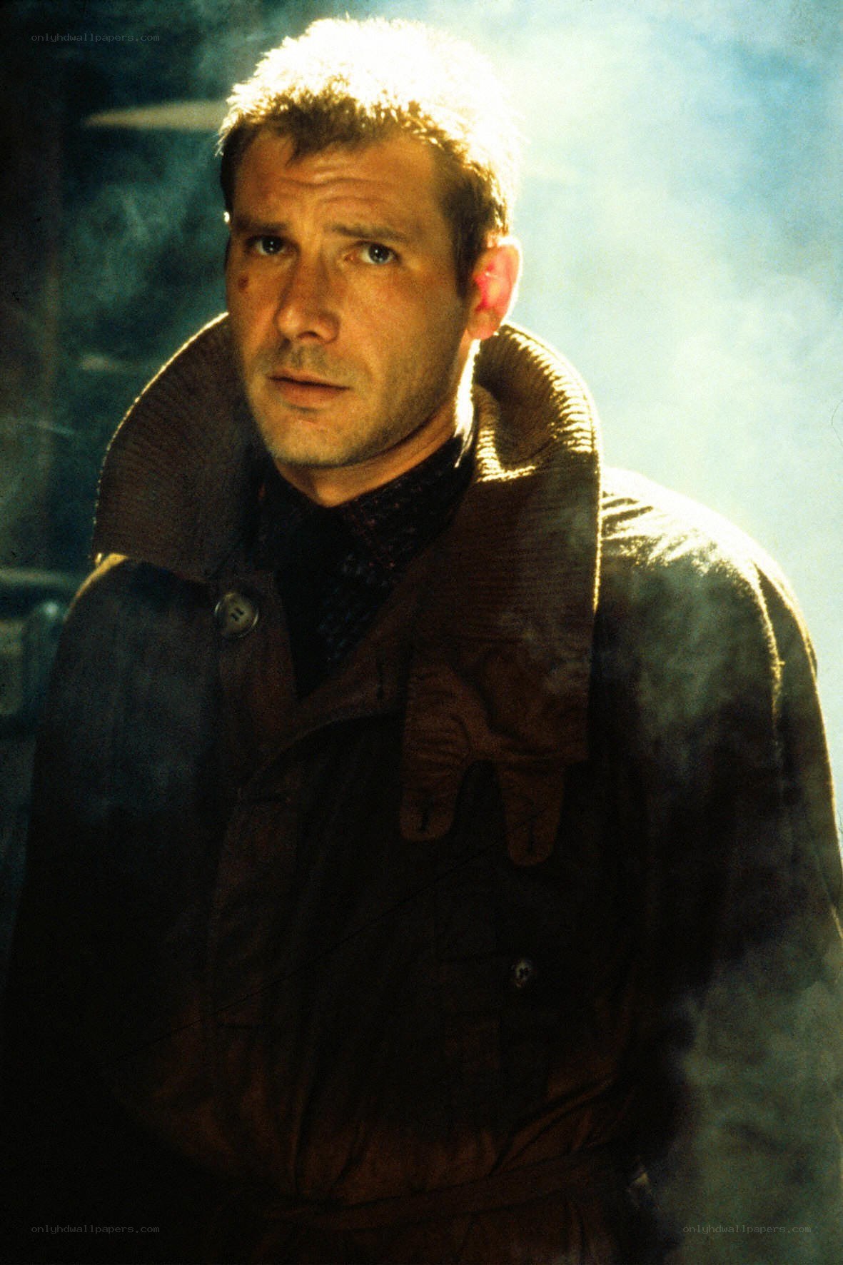 man in brown coat with light behind