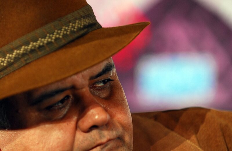 man in brown hat looking down