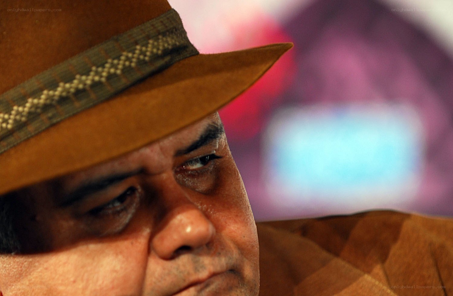 man in brown hat looking down