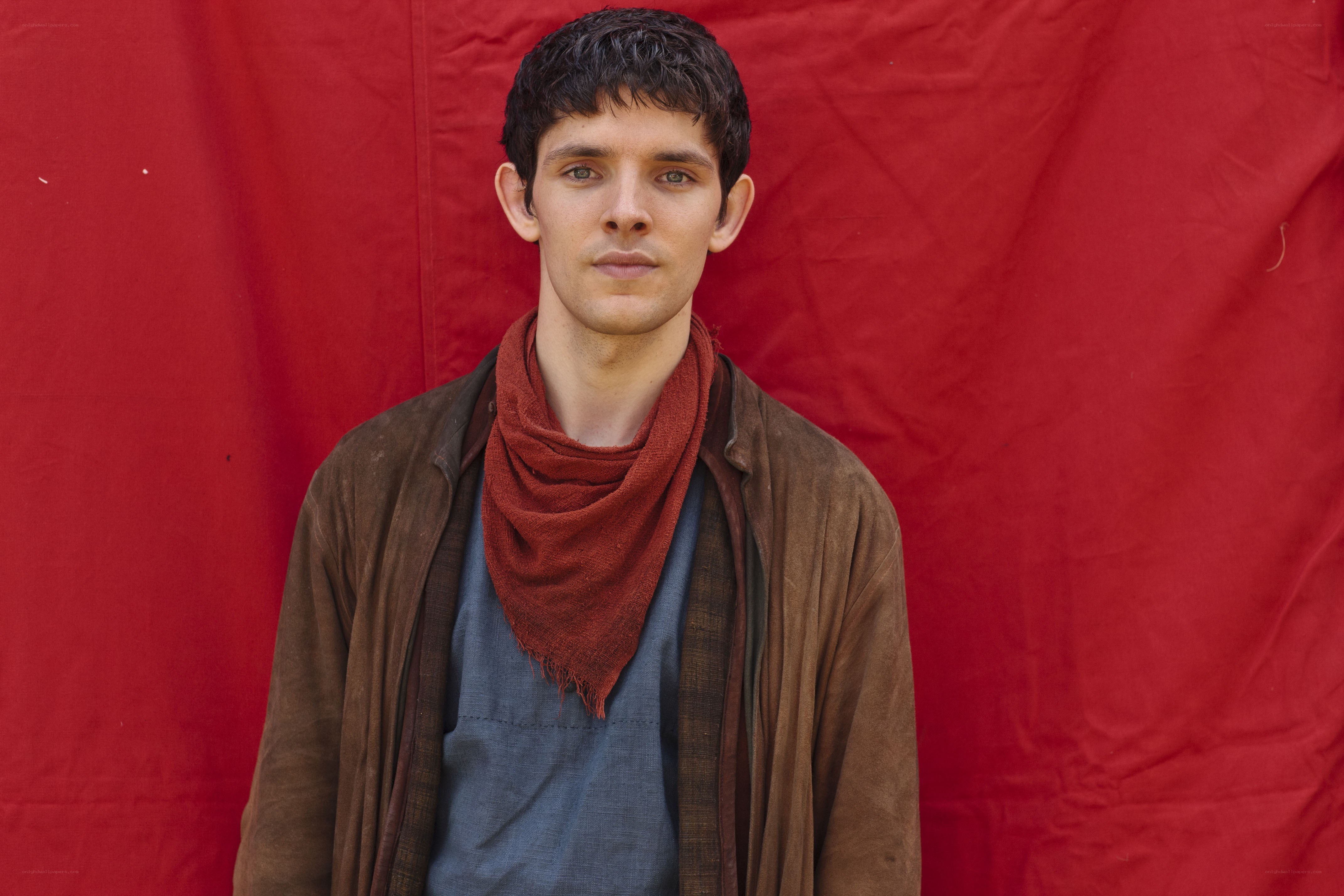 man in brown jacket and red scarf