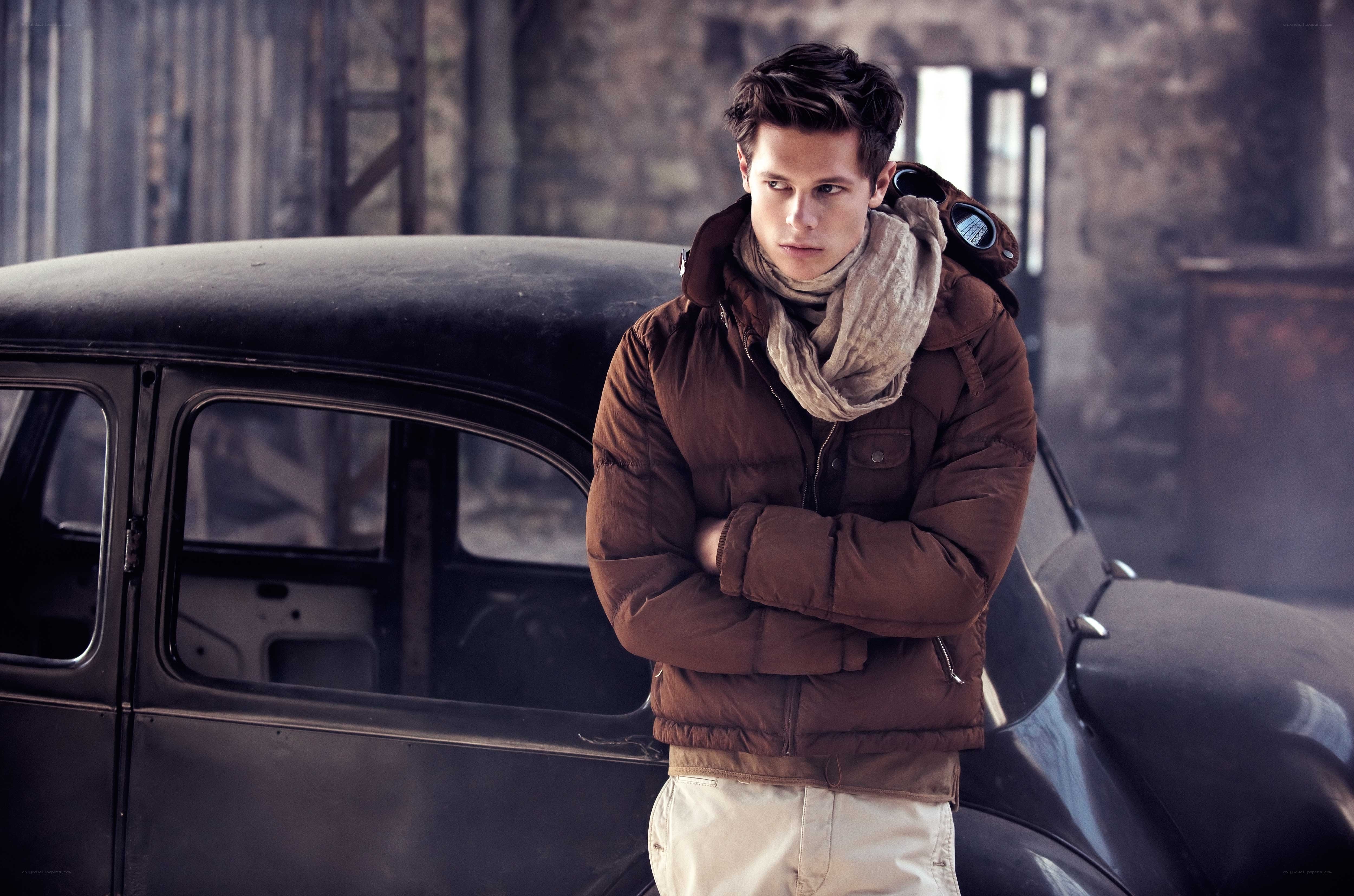 Man in brown jacket by vintage car