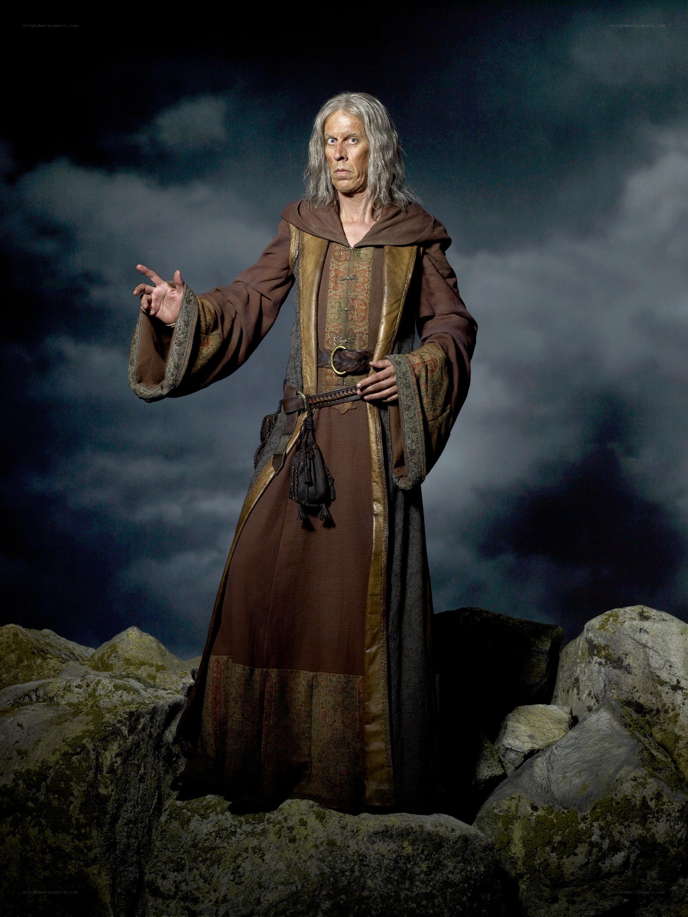 man in brown robe on rocks
