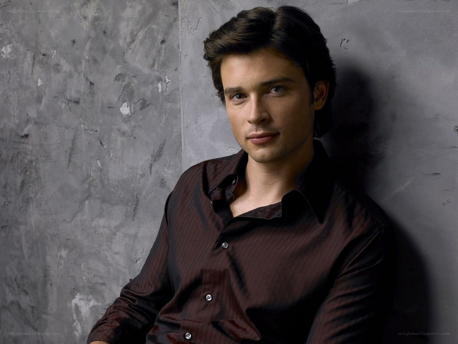 man in brown shirt leaning