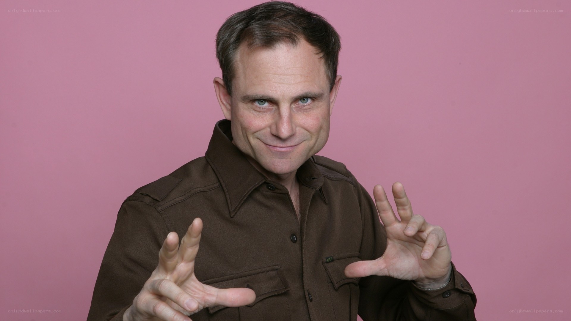 man in brown shirt smiling