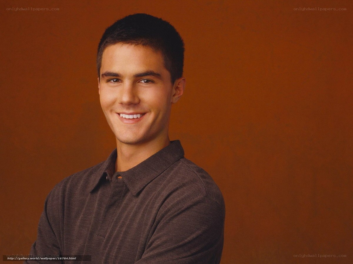 man in brown shirt smiling