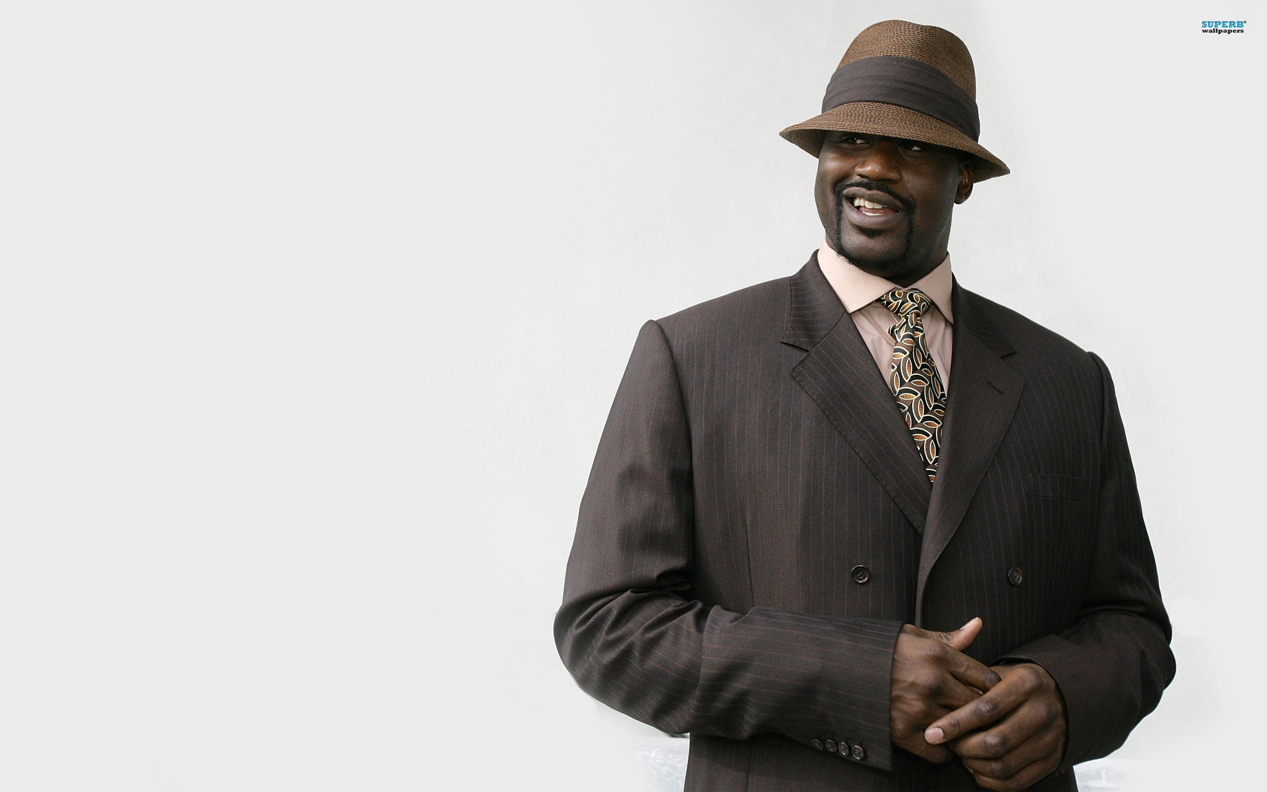 man in brown suit and hat