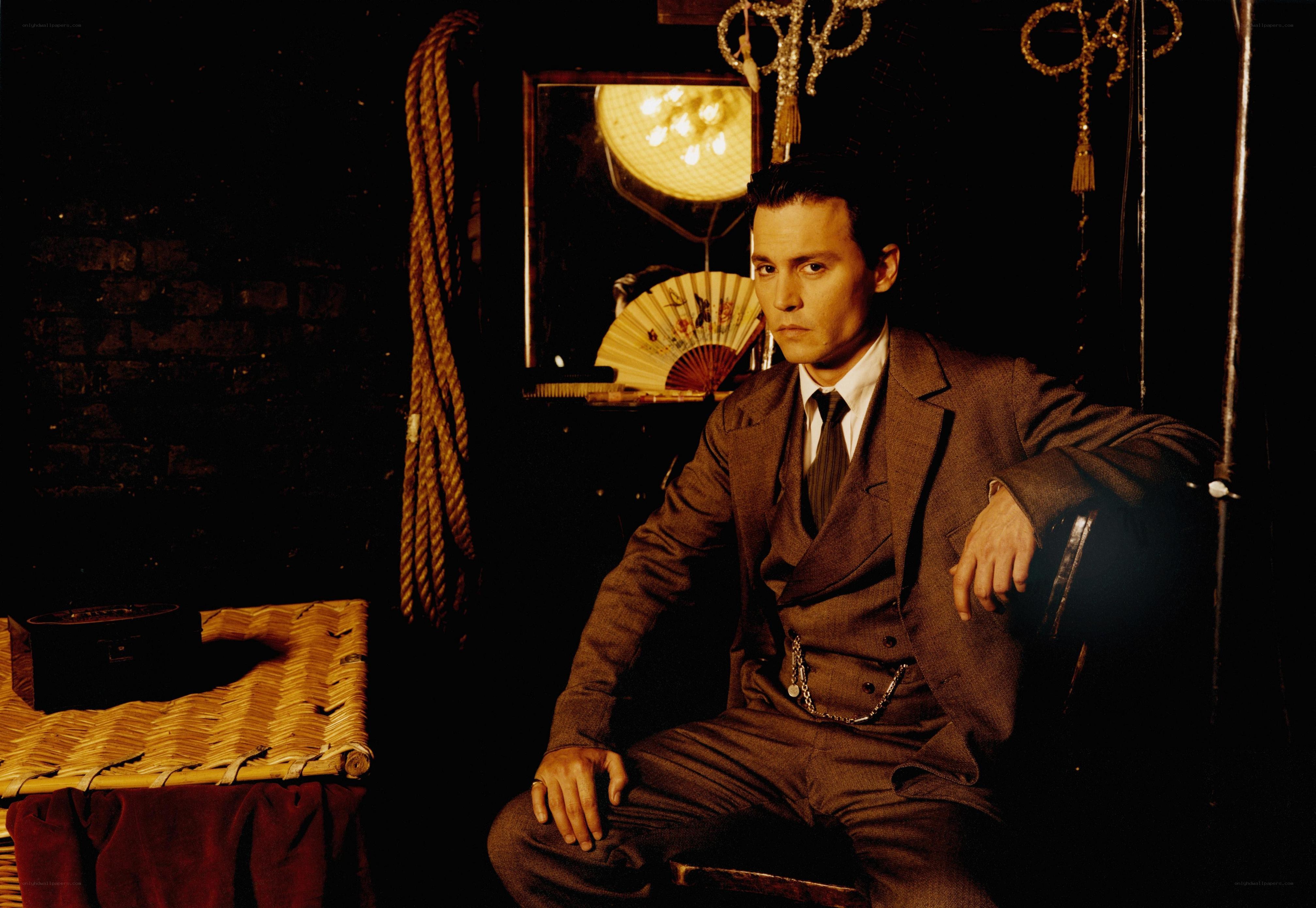 man in brown suit sitting