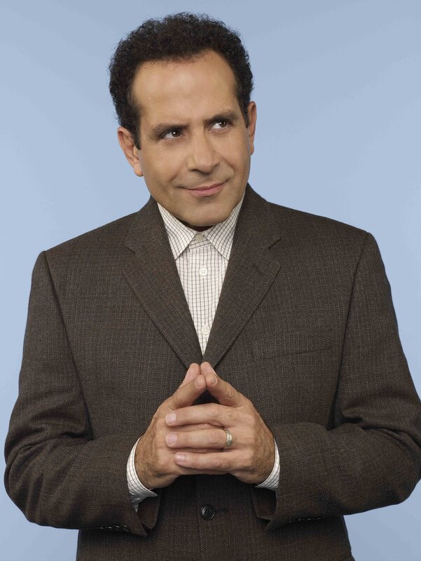 Man in brown suit smiling