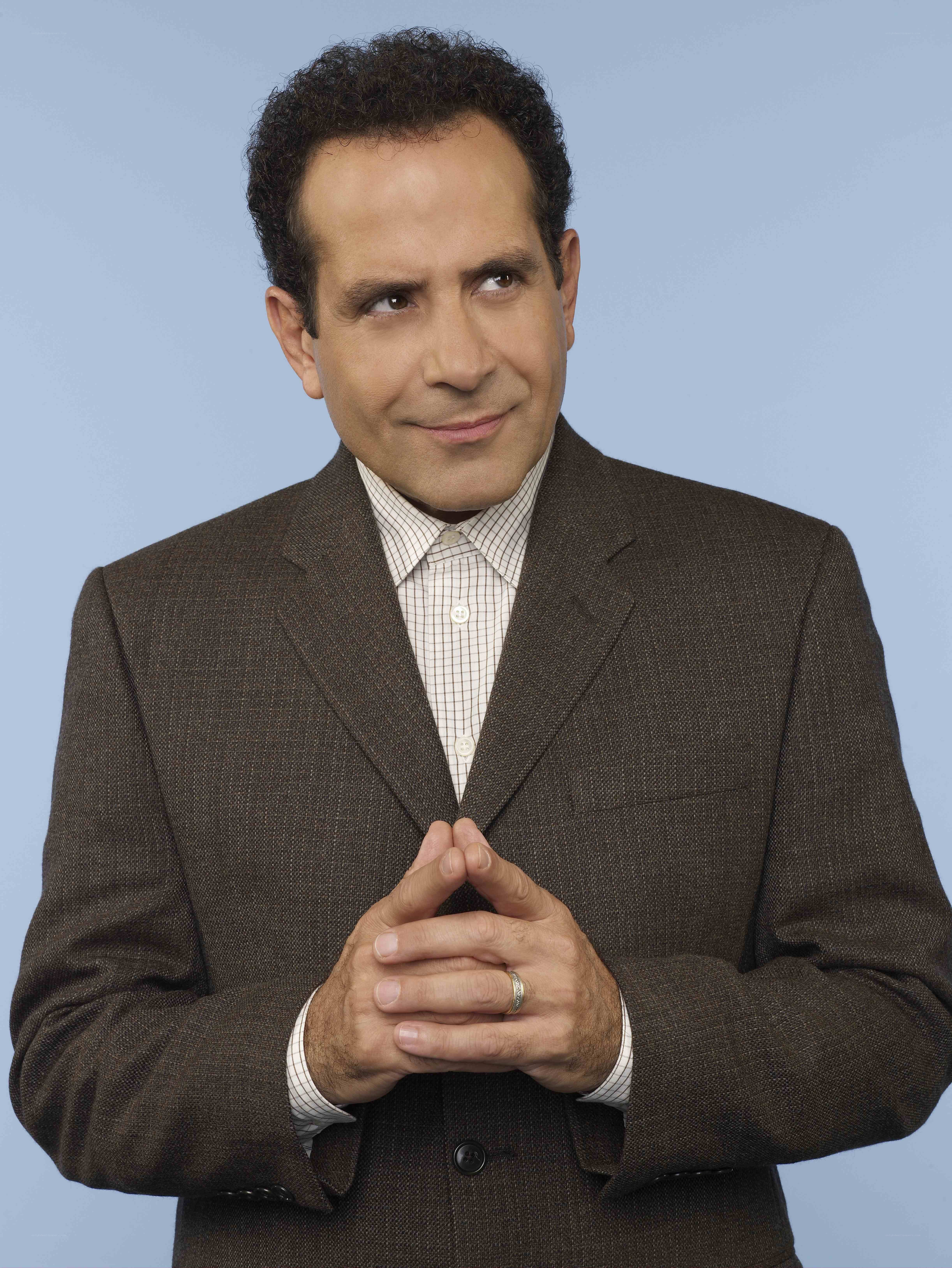 Man in brown suit smiling