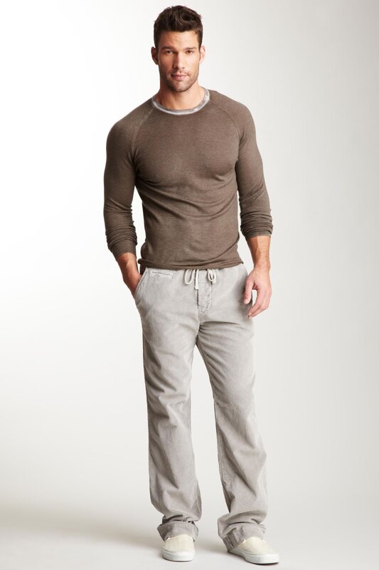 man in brown sweater and gray pants